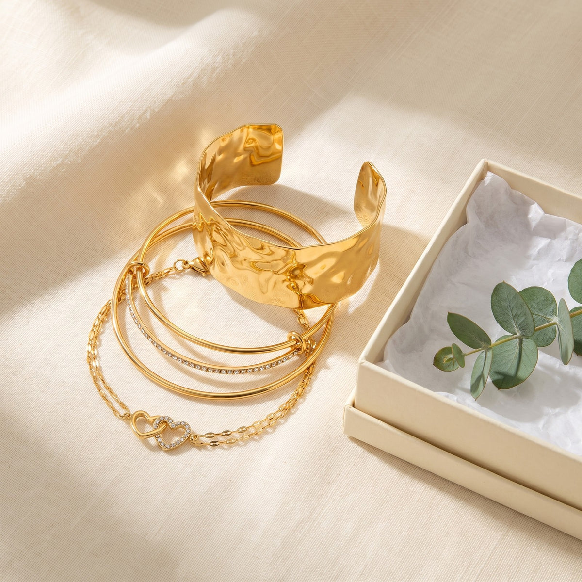 The Everyday Stack bracelets next to an open gift box
