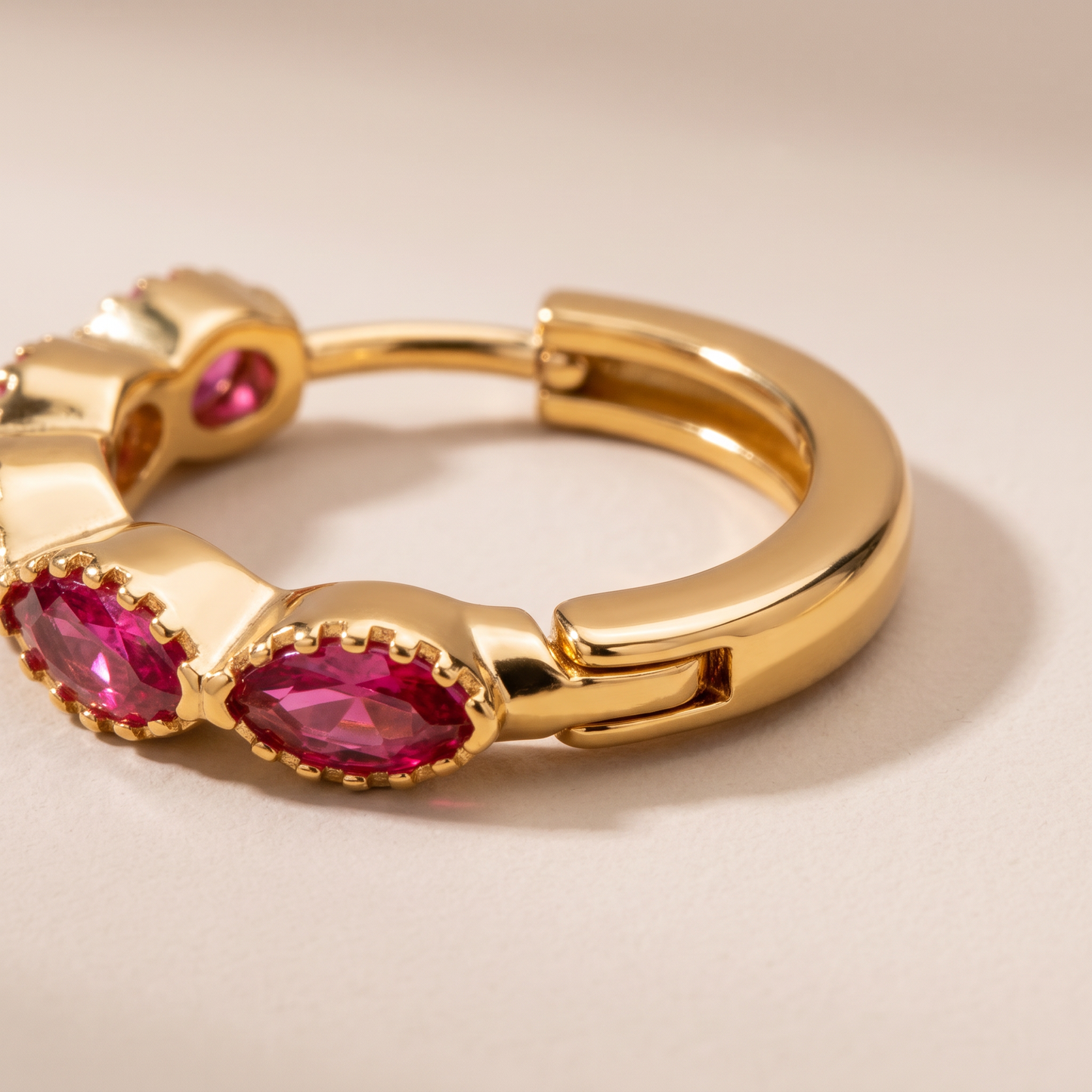 Asea Garnet Huggie Hoops — close-up detail